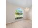 Bright, naturally lit living room with large arch window and elegant chandelier at 7431 Sw 129Th Pl, Ocala, FL 34473