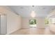 Bright living room featuring wood flooring, a chandelier, and a sliding glass door at 7431 Sw 129Th Pl, Ocala, FL 34473