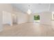 Bright, open-concept living room featuring new floors, vaulted ceilings, and sliding glass doors to the lanai at 7431 Sw 129Th Pl, Ocala, FL 34473