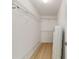 Walk-in closet with wire shelving and light wood floors at 7431 Sw 129Th Pl, Ocala, FL 34473
