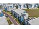 Aerial view of modern blue and gray townhomes with rooftop patios and manicured landscaping in a vibrant community at 7740 Sandy Ridge Dr # 236, Reunion, FL 34747