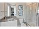 Modern bathroom featuring a tiled shower, sleek vanity, toilet, and mirror, providing a clean and stylish space at 7740 Sandy Ridge Dr # 236, Reunion, FL 34747