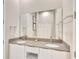 Bright bathroom featuring a double sink vanity with modern fixtures and a large mirror at 7740 Sandy Ridge Dr # 236, Reunion, FL 34747