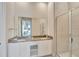 Modern bathroom with double vanity, glass shower, and neutral finishes at 7740 Sandy Ridge Dr # 236, Reunion, FL 34747