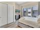 Bright bedroom with a large window, gray flooring, and sleek sliding-door closet at 7740 Sandy Ridge Dr # 236, Reunion, FL 34747