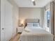 Comfortable bedroom with a queen bed, bedside table, lamp, and a view from the window at 7740 Sandy Ridge Dr # 236, Reunion, FL 34747
