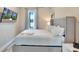 Bedroom with a queen-size bed, a window offering natural light, and a mounted TV at 7740 Sandy Ridge Dr # 236, Reunion, FL 34747