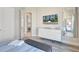 Chic bedroom with a wall-mounted TV, ample storage, and serene decor at 7740 Sandy Ridge Dr # 236, Reunion, FL 34747