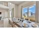 Bright dining area with white table setting, large windows, and modern decor at 7740 Sandy Ridge Dr # 236, Reunion, FL 34747