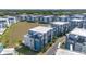 An aerial view of modern townhouse-style condos with manicured landscaping and a well-kept lawn at 7740 Sandy Ridge Dr # 236, Reunion, FL 34747