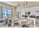 A modern kitchen is showcased with white cabinets, stainless steel appliances and an island with seating at 7740 Sandy Ridge Dr # 236, Reunion, FL 34747