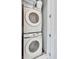 Efficient laundry space showcasing stacked Samsung washer and dryer units with bright natural light at 7740 Sandy Ridge Dr # 236, Reunion, FL 34747