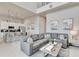 Open-concept living space with a sectional sofa, bar seating, and stainless steel appliances at 7740 Sandy Ridge Dr # 236, Reunion, FL 34747