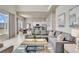 Bright living room with a comfortable sectional sofa, and a modern kitchen and dining area in the background at 7740 Sandy Ridge Dr # 236, Reunion, FL 34747