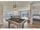 Inviting living room with pool table, comfortable seating, and balcony access at 7740 Sandy Ridge Dr # 236, Reunion, FL 34747