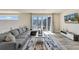 Living room with comfortable gray sofa, coffee table, and sliding glass doors to a balcony with table at 7740 Sandy Ridge Dr # 236, Reunion, FL 34747