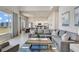 Bright living room with a comfortable sectional sofa, and a modern kitchen and dining area in the background at 7740 Sandy Ridge Dr # 236, Reunion, FL 34747
