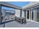 Modern outdoor patio featuring a sleek dining set, lounge chairs, and a contemporary design perfect for entertaining at 7740 Sandy Ridge Dr # 236, Reunion, FL 34747