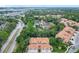 Aerial view of the townhome community with lush greenery and a nearby lake at 7806 Sugar Brook Ct # 7806, Orlando, FL 32819