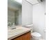 Bathroom features a vanity with a large mirror and a standard toilet at 7806 Sugar Brook Ct # 7806, Orlando, FL 32819