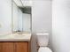 Bathroom features a vanity, standard toilet and a large mirror at 7806 Sugar Brook Ct # 7806, Orlando, FL 32819