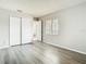 Bedroom with wood-look flooring, closet and natural light from the window at 7806 Sugar Brook Ct # 7806, Orlando, FL 32819