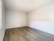 Cozy bedroom with wood-look flooring and natural light from the window at 7806 Sugar Brook Ct # 7806, Orlando, FL 32819