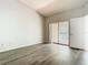This bedroom has a sliding glass door and gray wood flooring at 7806 Sugar Brook Ct # 7806, Orlando, FL 32819