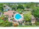 Aerial view showcases the community pool and surrounding vegetation at 7806 Sugar Brook Ct # 7806, Orlando, FL 32819