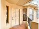 Close-up of the townhome's front door with sidelight, secure entrance, and building number at 7806 Sugar Brook Ct # 7806, Orlando, FL 32819