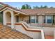 Exterior view of the townhome's second-story entrance, showcasing tiled accents and secure access at 7806 Sugar Brook Ct # 7806, Orlando, FL 32819
