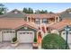 Inviting two-story townhome showcasing a red tile roof, stucco facade, and well-maintained landscaping at 7806 Sugar Brook Ct # 7806, Orlando, FL 32819
