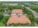 Aerial view of luxurious townhomes with red roofs and garages nestled in a leafy neighborhood at 7806 Sugar Brook Ct # 7806, Orlando, FL 32819
