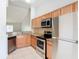 Functional kitchen features granite countertops, stainless steel appliances, and ample cabinet space at 7806 Sugar Brook Ct # 7806, Orlando, FL 32819