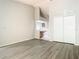 Bright living room features wood-look flooring, neutral paint, and access to kitchen at 7806 Sugar Brook Ct # 7806, Orlando, FL 32819