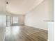 Bright living room featuring wood flooring, neutral paint, and natural light from sliding glass doors at 7806 Sugar Brook Ct # 7806, Orlando, FL 32819