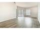 Open living room featuring wood-look flooring, and sliding glass doors to balcony at 7806 Sugar Brook Ct # 7806, Orlando, FL 32819