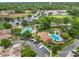 Aerial view of the community pool, tennis courts, and nearby baseball field surrounded by lush greenery at 7806 Sugar Brook Ct # 7806, Orlando, FL 32819