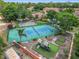 Aerial shot of the tennis court and nearby playground, surrounded by lush greenery at 7806 Sugar Brook Ct # 7806, Orlando, FL 32819