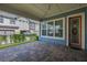 Inviting back porch with brick pavers, string lights, and access to the lush backyard at 7878 Greengard St, Orlando, FL 32827