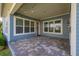 Charming back porch featuring brick pavers, string lights, and a welcoming outdoor atmosphere at 7878 Greengard St, Orlando, FL 32827