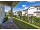 Backyard view with well-maintained lawn, fence, and glimpses of neighboring townhomes at 7878 Greengard St, Orlando, FL 32827