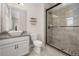 Modern bathroom with granite vanity, glass shower with tile surround, and neutral color palette at 7878 Greengard St, Orlando, FL 32827