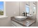 Bright bathroom featuring a stylish vessel sink atop a granite countertop and a large mirror at 7878 Greengard St, Orlando, FL 32827