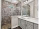 Bathroom boasts a single sink, walk-in shower, stone accents, and attractive tile flooring at 7878 Greengard St, Orlando, FL 32827