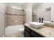 Well-lit bathroom featuring a tub with tile surround, granite counters, and a vessel sink at 7878 Greengard St, Orlando, FL 32827