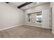 Bedroom featuring carpet floors, a large window, and wooden ceiling beams at 7878 Greengard St, Orlando, FL 32827