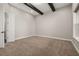 Bedroom featuring carpet floors, a large window, and wooden ceiling beams at 7878 Greengard St, Orlando, FL 32827