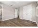 Bedroom with hardwood floors, closet, and an ensuite bathroom; providing comfort and privacy at 7878 Greengard St, Orlando, FL 32827