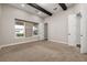 Bedroom featuring carpet floors, a large window, and wooden ceiling beams at 7878 Greengard St, Orlando, FL 32827